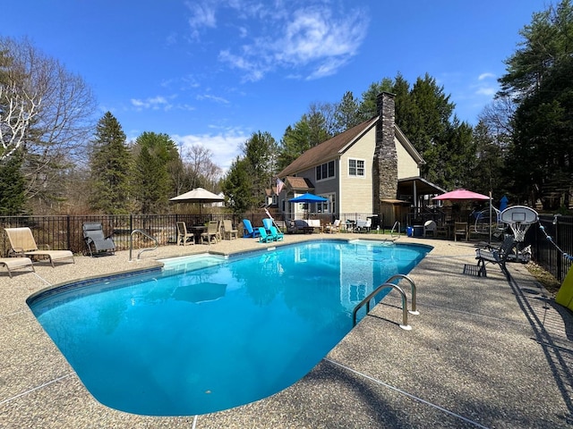 view of swimming pool with a patio, fence, and a fenced in pool