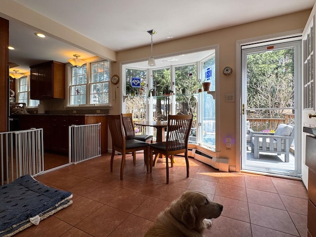 dining space with tile patterned floors, baseboard heating, and recessed lighting
