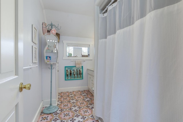 full bath featuring baseboards and tile patterned flooring