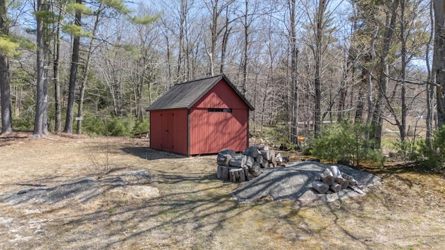 view of shed with a forest view