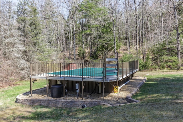 view of pool with a fenced in pool, a yard, and a deck