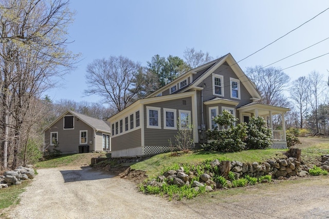 view of side of home featuring central air condition unit and covered porch