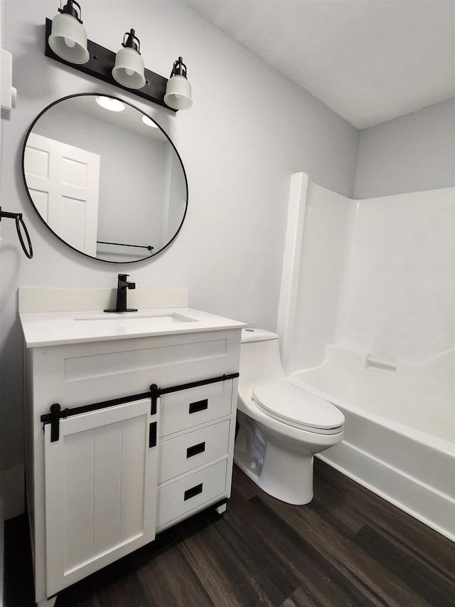 full bathroom with shower / bath combination, vanity, toilet, and wood finished floors