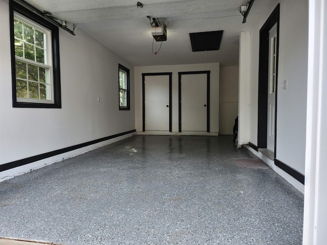 garage featuring baseboards and a garage door opener