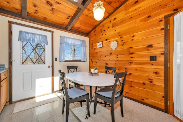 dining room featuring vaulted ceiling with beams and wood ceiling