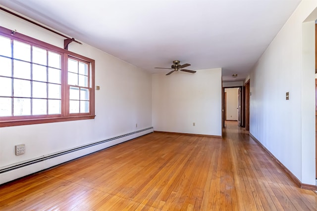 unfurnished room with baseboards, ceiling fan, a baseboard heating unit, and light wood finished floors