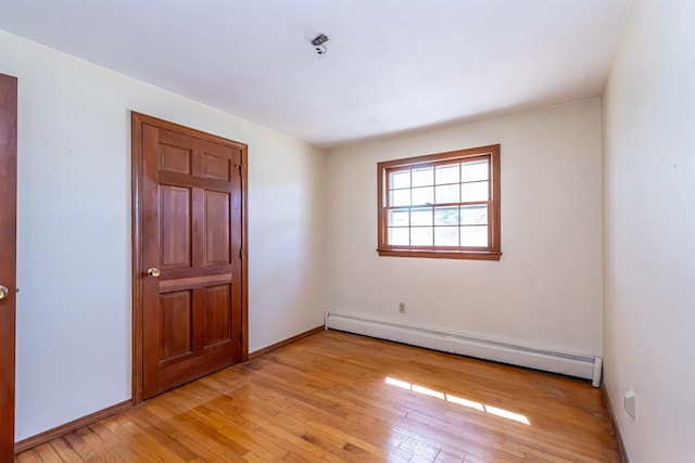 interior space featuring light wood-type flooring, baseboards, and baseboard heating