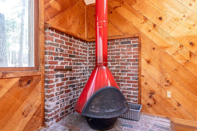details featuring a wood stove and wood walls
