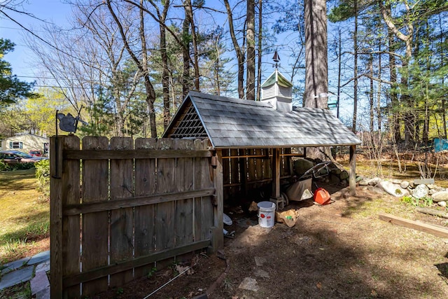 view of outbuilding with fence