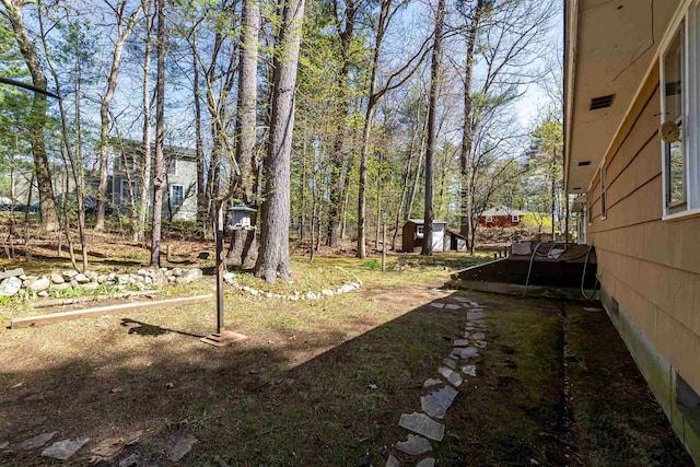 view of yard with a storage shed and an outdoor structure