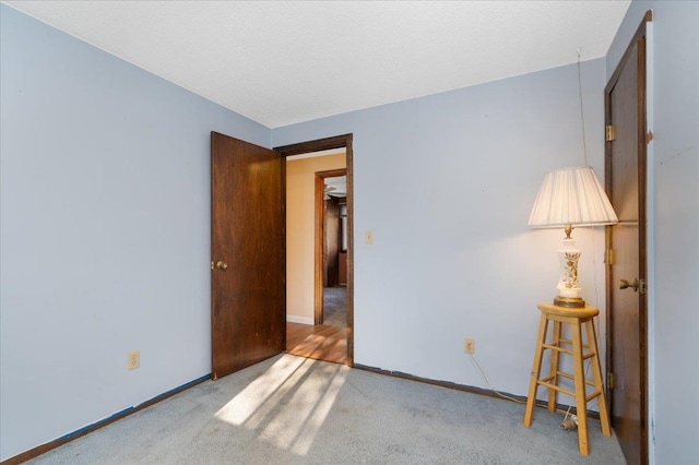 unfurnished bedroom with carpet floors and baseboards
