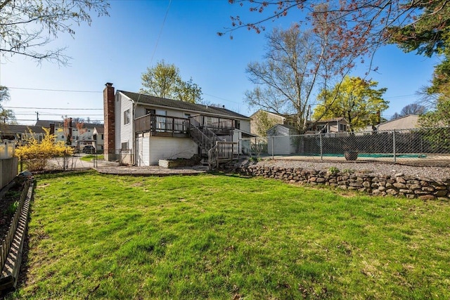 view of yard featuring a fenced backyard, stairway, and a deck