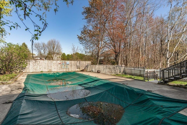 view of swimming pool featuring a fenced in pool, a fenced backyard, and a patio area