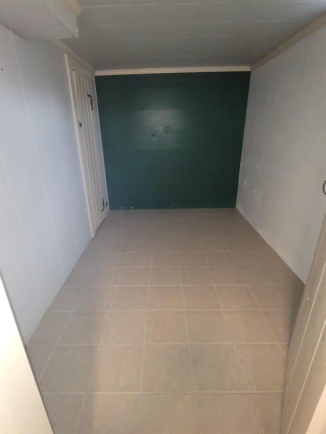 hallway featuring crown molding and light tile patterned floors