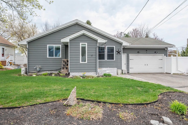 view of front of home featuring a garage, a front lawn, and aphalt driveway