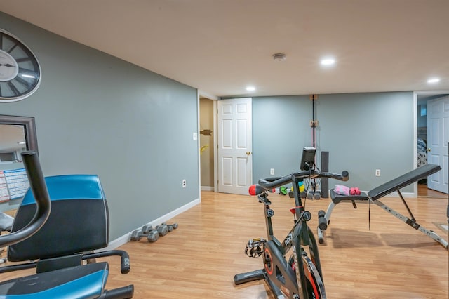 exercise room featuring recessed lighting, baseboards, and wood finished floors