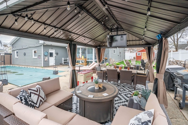 view of patio with fence, outdoor dining space, a gazebo, a fenced in pool, and an outdoor living space
