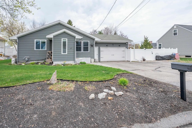 ranch-style home featuring concrete driveway, an attached garage, fence, and a front lawn