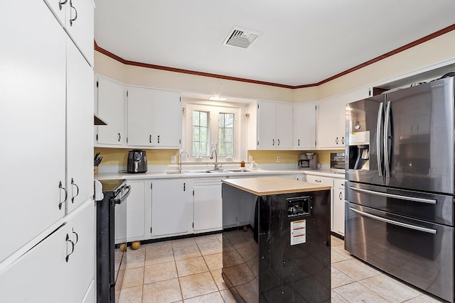 134 Emerson Ave, Hampstead, NH 03841 - kitchen featuring stainless steel appliances, light countertops, light tile patterned floors, a kitchen island, and crown molding