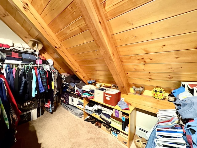 interior space with carpet flooring and vaulted ceiling with beams