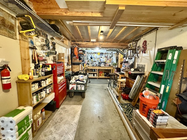 unfinished basement featuring a workshop area
