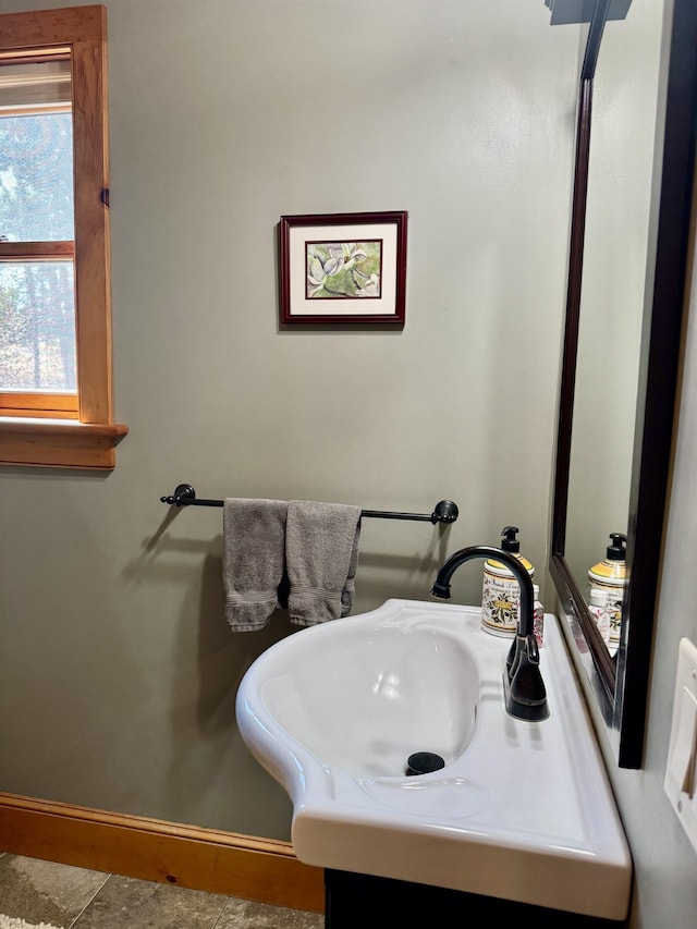 bathroom with baseboards and vanity