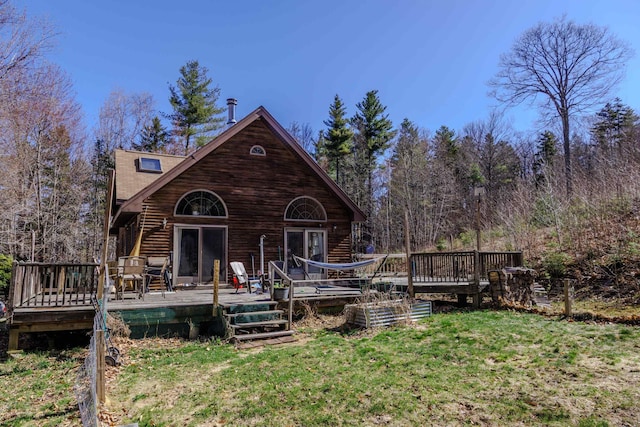 back of property featuring a yard and a deck