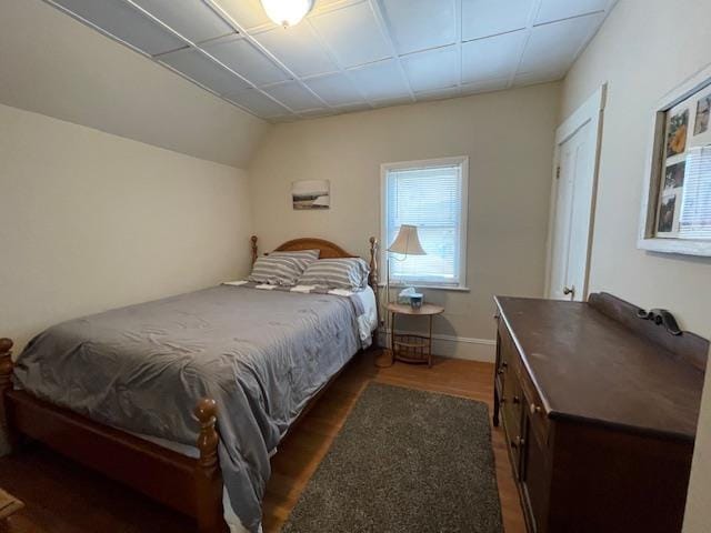 bedroom with baseboards and wood finished floors