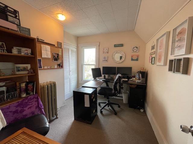 office area featuring carpet flooring and radiator