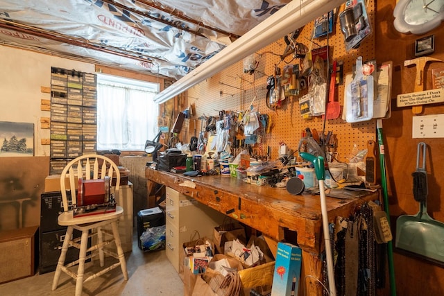 miscellaneous room featuring a workshop area and concrete floors