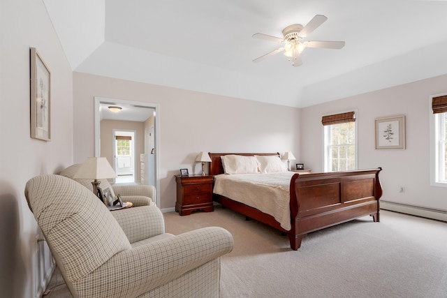 bedroom with baseboards, multiple windows, baseboard heating, and light carpet