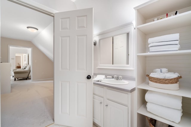 bathroom featuring vanity and lofted ceiling