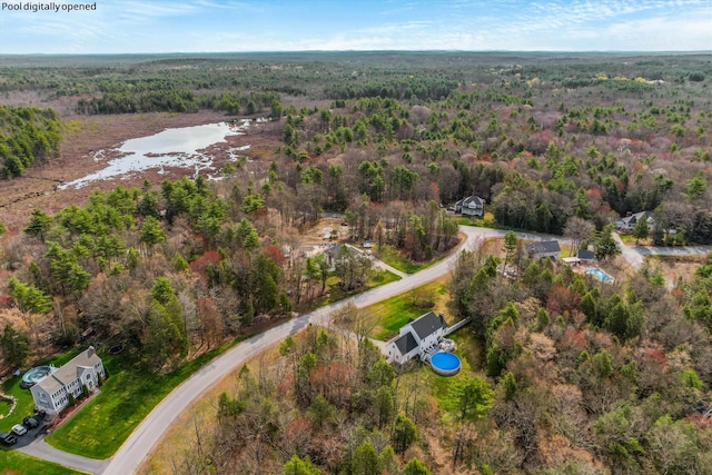 aerial view featuring a water view and a view of trees