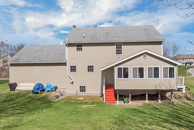 rear view of property with a lawn, a chimney, and stairs