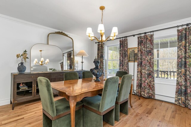 dining area featuring an inviting chandelier, a baseboard radiator, crown molding, and light wood-type flooring