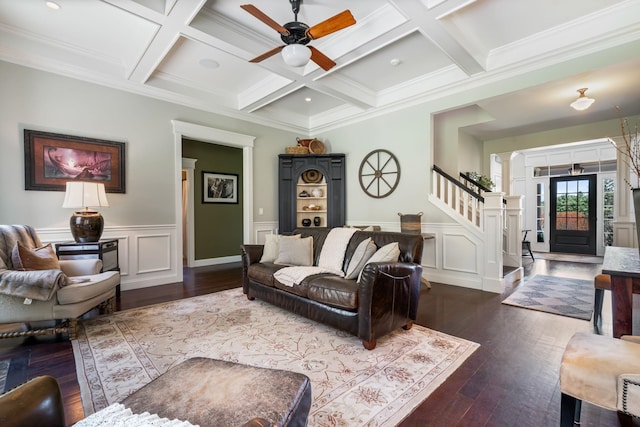 living room featuring stairway, coffered ceiling, a ceiling fan, and dark wood-type flooring