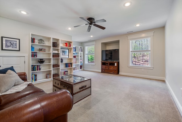 living room featuring baseboards, ceiling fan, light carpet, and recessed lighting