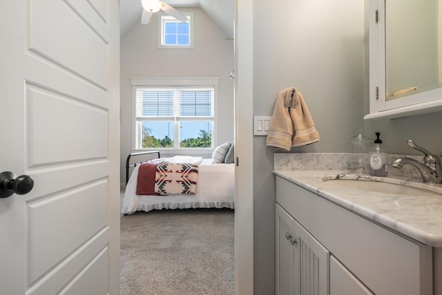bathroom featuring vanity, a ceiling fan, connected bathroom, and lofted ceiling