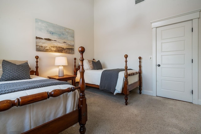 carpeted bedroom with baseboards and visible vents