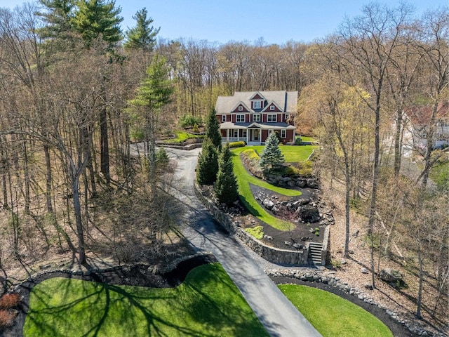 drone / aerial view with a wooded view