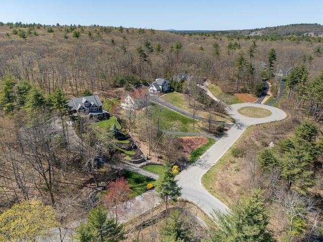 drone / aerial view featuring a wooded view