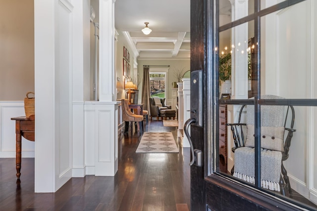 hallway with a decorative wall, beam ceiling, a wainscoted wall, coffered ceiling, and dark wood-type flooring