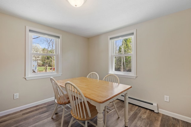 dining room with baseboards, baseboard heating, and a healthy amount of sunlight