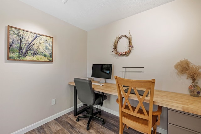 office space with baseboards, built in study area, and wood finished floors