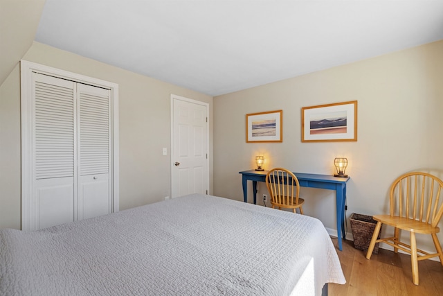 bedroom featuring a closet and light wood-style flooring
