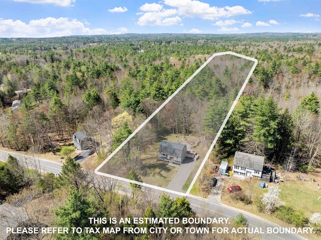 aerial view featuring a wooded view