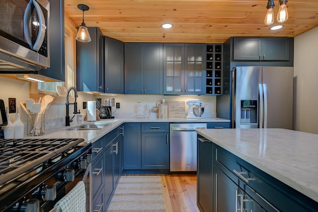 kitchen with a sink, wood ceiling, stainless steel appliances, and light wood-style flooring
