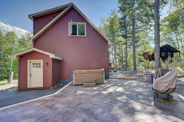 exterior space with a patio and a hot tub