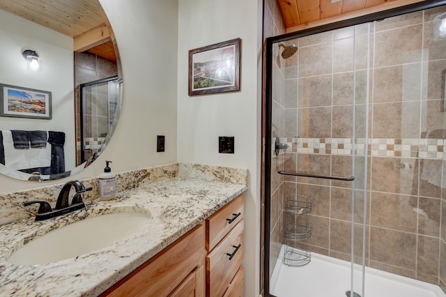 full bath featuring vanity and a shower stall