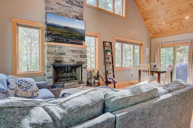 living room with plenty of natural light, a fireplace, wood finished floors, and high vaulted ceiling